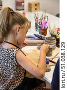 Girl Makes Art out of Clay in Her Pottery Class at the Art Center. Стоковое фото, фотограф Aleksandr Golubev / Фотобанк Лори