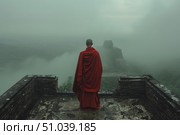 Buddhist monk observing foggy landscape from ancient temple. Стоковое AI-изображение, AI-художник Иван Рябоконь / Фотобанк Лори