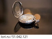 Vintage mechanical pocket watch in gold or brass color made of metal. Dial with Roman numerals. Стоковое фото, фотограф Наталия Кирсанова / Фотобанк Лори