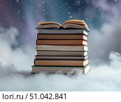 Книги на фоне дыма и снежинок. Стоковое AI-изображение, AI-художник Boostport / Фотобанк Лори