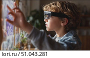 Boy explores augmented reality technology in a cozy indoor setting. Стоковое AI-видео, аниматор Сергей Толмачёв / Фотобанк Лори