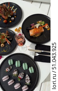 Grilled salmon steak with crispy skin sauteed vegetables and lemon served in outdoor restaurant in summer light A wooden table with a variety of dishes containing seafood, vegetables and fruit.Hand holding a spoon ready to eat pineapple fried rice with shrimp, served in a pineapple bowl, surrounded by fresh fruits and tea on a cozy table setting.Party Sea Food platter with salmon and prawns, low angle view, close-up Sea food party platter, extreme Whole poached salmon with cucumber slices for scales, high end party platter, overhead view Tiger prawns on the grill Macarooni cookies floating on blue background, levitation, macarooni cookies, dessert, sweets, colorful, delicious Two Glasses of Pink Champagne with Macarons and Oranges Elegant seaside celebration with seafood, pink floral decor, and sparkling wine overlooking the ocean. Стоковое видео, видеограф Zita Khasanova / Фотобанк Лори