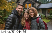Happy man and woman are standing in front of a house, possibly discussing or observing. The scene captures their interaction in front of the residential building. Стоковое AI-видео, аниматор Данила Большаков / Фотобанк Лори