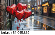 A cluster of heart-shaped balloons glistens in the rain, adding charm to a charming town street bustling with pedestrians at twilight. Стоковое AI-видео, аниматор Данила Большаков / Фотобанк Лори