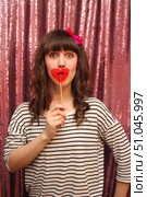 Young woman in front of glittering  background holding lolipop in her hands. Стоковое фото, фотограф Максимова Марина / Фотобанк Лори