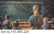 Children seated in rows, facing a blackboard with chalk writings. Some raising hands, others looking attentive. Стоковое AI-видео, аниматор Данила Большаков / Фотобанк Лори