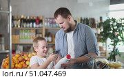 Father and son boy in store scans QR code on milk bottle. With help of mobile app, buyer receives information about product. They checks manufacturers data in registry database of national agency. Стоковое видео, видеограф Яков Филимонов / Фотобанк Лори