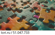 A detailed view of a single, colorful puzzle piece, showing intricate patterns and vibrant colors. Стоковое AI-видео, аниматор Данила Большаков / Фотобанк Лори