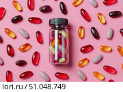 Vitamin and health supplement white blank bottle with colorful pills flying out on a pink background. Flat lay, top view. Space for text. Bottle of various types multivitamins and tablets composition. Стоковое AI-изображение, AI-художник Марина Демидюк / Фотобанк Лори