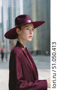 Fashion model posing in maroon suit and hat in urban setting. Стоковое AI-видео, аниматор Юрий Поздников / Фотобанк Лори