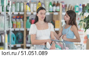 Tired mother with capricious daughter buyers choose products in household chemicals store. Стоковое видео, видеограф Яков Филимонов / Фотобанк Лори