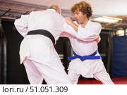 Karate with male athletes practicing, training and sparring in fight class. Стоковое фото, фотограф Яков Филимонов / Фотобанк Лори