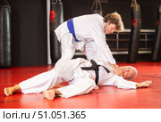 Middle‑aged aikido practitioner training with partner in dojo. Стоковое фото, фотограф Яков Филимонов / Фотобанк Лори