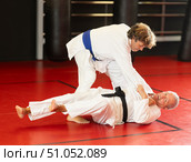 Karate with male athletes practicing, training and sparring in fight class. Стоковое фото, фотограф Яков Филимонов / Фотобанк Лори