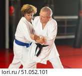 Senior aikido practitioner training with partner in dojo. Стоковое фото, фотограф Яков Филимонов / Фотобанк Лори
