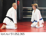 Karate student and sensei in white gi bowing in dojo. Стоковое фото, фотограф Яков Филимонов / Фотобанк Лори