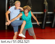 Middle-aged man enduring painful arm lock during training sparring. Стоковое фото, фотограф Яков Филимонов / Фотобанк Лори