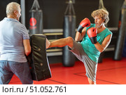 Middle‑aged man striking shield in self‑defense drill. Стоковое фото, фотограф Яков Филимонов / Фотобанк Лори