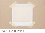 Empty vintage instant photo frame taped to cardboard background, retro picture mockup for your personal image or precious memories. Стоковое AI-изображение, AI-художник Павел Муравьев / Фотобанк Лори