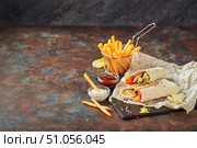 Eastern traditional shawarma, and French fries with sauces on slate. Стоковое фото, фотограф Ирина Буракова / Фотобанк Лори