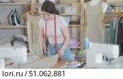 Young woman professional working cut material at sewing atelier. Стоковое видео, видеограф Яков Филимонов / Фотобанк Лори