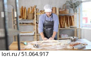 Process of making baguette, loaf or bread in bakery - baker kneads and rolls the dough to give the shape of the future bread. Стоковое видео, видеограф Яков Филимонов / Фотобанк Лори