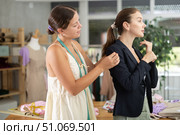 Young tailoress trying ready jacket on female client. Стоковое фото, фотограф Яков Филимонов / Фотобанк Лори
