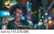 African American woman with glasses is focusing on a tablet screen, scrolling and reading intently. Стоковое AI-видео, аниматор Данила Большаков / Фотобанк Лори
