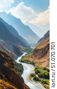 Scenic river winds through dramatic mountain valley with terraced fields and lush greenery under a bright sky, showcasing untouched nature and majestic landscapes. Стоковое AI-изображение, AI-художник Катерина Бондарец / Фотобанк Лори