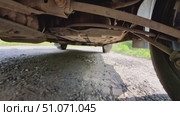 A car is parked on a dirt road with grass growing around it. Стоковое видео, видеограф Ярославский Максим / Фотобанк Лори