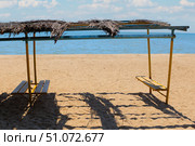 Sunshade made from reed stems on the beach by the sea. Стоковое фото, фотограф Юрий Бизгаймер / Фотобанк Лори