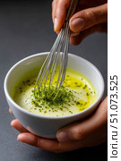 Chef whisking matcha powder into golden milk latte beverage. Стоковое AI-изображение, AI-художник Юрий Поздников / Фотобанк Лори