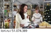 Woman with cheese and meat choosing food at grocery store. Стоковое видео, видеограф Яков Филимонов / Фотобанк Лори