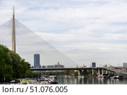 Scenic view of a Bridge with boats docked on the riverbank and a modern skyline in the background. Стоковое фото, фотограф Виктор Ветошкин / Фотобанк Лори