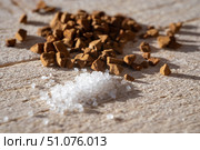 Close-up of coarse sugar crystals and instant coffee granules scattered on a wooden surface. Стоковое фото, фотограф Виктор Ветошкин / Фотобанк Лори