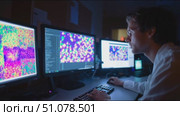 Scientist analyzes colorful data on multiple screens in a lab at night. Стоковое AI-видео, аниматор Сергей Толмачёв / Фотобанк Лори