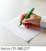 Close-Up of a Hand Holding a Green Pen Over a White Sheet of Paper. Generative AI. Стоковое AI-изображение, AI-художник Roman Zavorotny / Фотобанк Лори