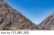Ruins of an ancient Inca city on a mountainside. Dilapidated stone buildings. Modern rural houses can be seen in the valley. Clear blue sky. Ollantaytambo. Peru. Cusco. Sacred Valley of the Incas. Стоковое фото, фотограф Вера Ивановна Кубарева / Фотобанк Лори