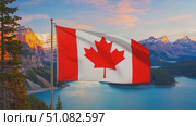 A Canadian flag waves in the foreground with a scenic view of mountains and a lake in the background. The sky is painted with warm sunset colors. Стоковое AI-видео, аниматор Nart / Фотобанк Лори
