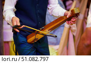 Stringed musical instrument lyre and bow in the hands of a male musician. Стоковое фото, фотограф Наталия Кирсанова / Фотобанк Лори