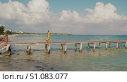 Woman in summer dress walks on wooden pier over turquoise ocean water in Mexico. Стоковое видео, видеограф Ольга Сухарева / Фотобанк Лори