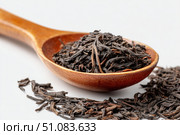Dry black tea leaves in a wooden spoon isolated on white background. Pile of Dried fermented tea. Black Tea Leaves Heap. Close Up, Macro. Texture. Copy Space. Dried Tea. Abstract Food Drink Backdrop. Стоковое AI-изображение, AI-художник Марина Демидюк / Фотобанк Лори