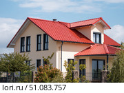House Exterior. Roof Window. Second floor among blue sky. Mansard attic. Newly build houses. Gable roof with skylight, asphalt roofing, shingles. Residential Home. Vinyl Siding. Polymeric roof-tiles. Стоковое AI-изображение, AI-художник Марина Демидюк / Фотобанк Лори