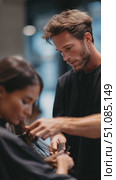 Hair stylist crafts a trendy look for a client in a modern salon setting with a relaxed atmosphere. Стоковое AI-видео, аниматор Сергей Толмачёв / Фотобанк Лори
