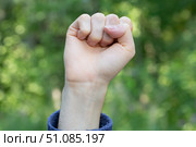 A raised clenched fist. Protests in the city. A concept. Стоковое фото, фотограф Александр Поташев / Фотобанк Лори