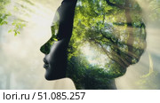 A silhouette of a woman with a profile view, filled with lush green trees and sunlight filtering through. The scene symbolizes nature and environmental awareness. Стоковое AI-видео, аниматор Nart / Фотобанк Лори