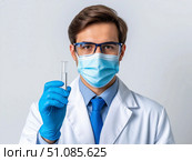 Doctor in medical mask and rubber gloves, holds in her hands, closeup of test tube. Стоковое AI-изображение, AI-художник Ирина Гильмуллина / Фотобанк Лори