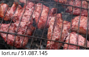 Pork Butt sliced on BBQ. Shish kebab. Pieces of pork on the grid, grilled meat with smoke. Food preparation process. Marinated spiced fillet meat cooked on charcoal barbeque grill. Outdoors cooking. Стоковое видео, видеограф Марина Демидюк / Фотобанк Лори