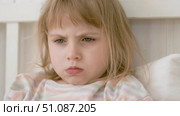 4 years girl joking, sticking tongue out with silly expression. Child making face. Funny foolishness portrait of little kid doing crazy comical gesture among a white wall. Closeup face. Low contrast. Стоковое видео, видеограф Марина Демидюк / Фотобанк Лори