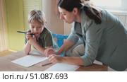 Mom education son writing. Kids learn and study in home school. Mommy female helping teaching little boy support studying, learning homework. Child care teach study. Knowledge day. Children schooling. Стоковое видео, видеограф Марина Демидюк / Фотобанк Лори